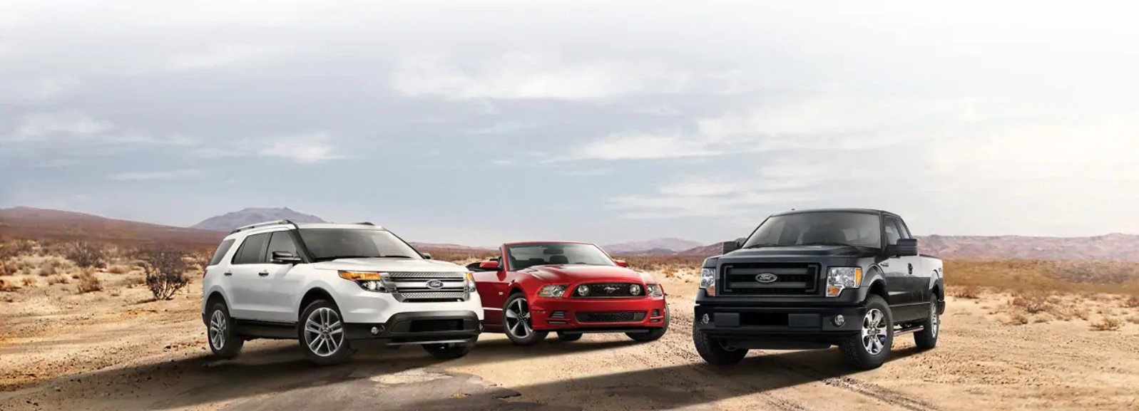 Ford SUV, sports car, and truck in a desert landscape showcasing versatility and performance.