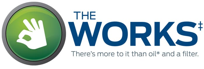 The Works logo featuring a green circle with a hand sign and the phrase "There's more to it than oil and a filter."